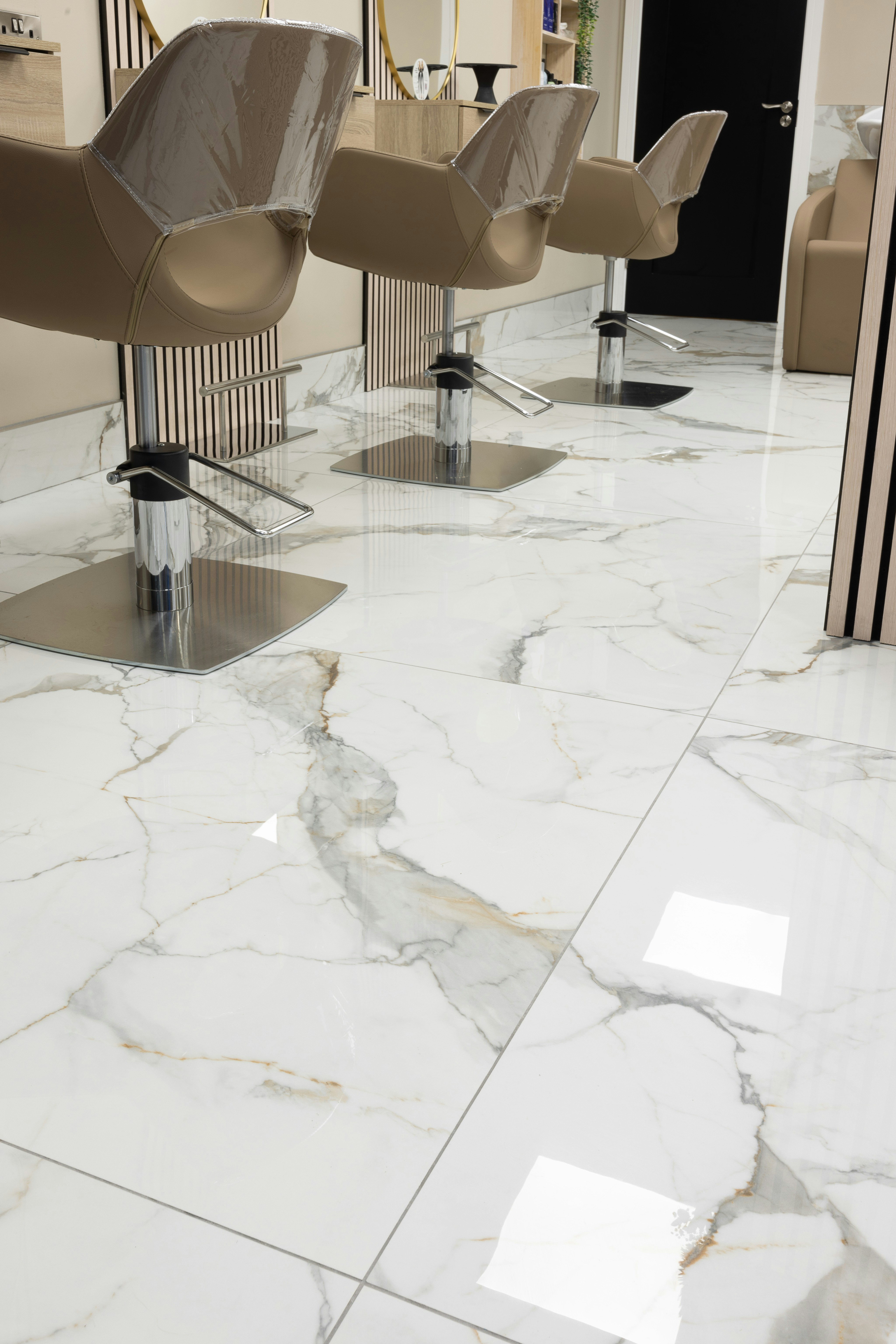 “Tile flooring with a stone-like pattern, featuring smooth, evenly spaced tiles in neutral tones.”